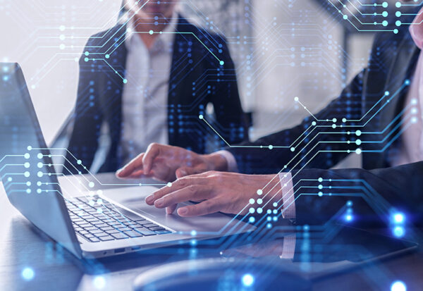 Two information technology specialist brainstorming on project to create a new approach to develop software to improve business service. Working with laptop. Tech hologram icons. Formal wear.